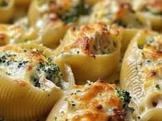 a close up view of some pasta shells with broccoli and cheese on it