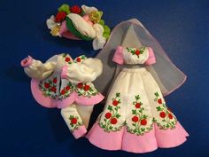 two wedding dolls are sitting next to each other