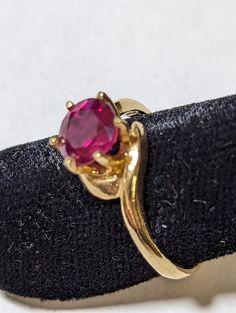 Although the majority of the jewelry I create uses cabochons, I also facet gemstones (see certificate) and usually mount faceted stones in cast settings that I purchase.  This natural ruby (5 mm round) is from an old stock of faceting rough and has excellent color and brilliance.  The 14K gold setting (size 6 1/2) elegantly sets it off. Ruby Birthstone Ring With Round Stone, Formal Round Ruby Ring In Fine Jewelry Style, Birthstone Ruby Ring, Oval Ruby Ring Stamped 14k, Round Ruby Birthstone Ring Stamped 14k, Gold Ruby Ring With Round Stone, Fine Jewelry, Ruby Birthstone Ring With Round Band, Formal Ruby Birthstone Ring Stamped 14k, Formal Ruby Gemstone Ring