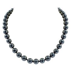 8mm Hematite Bead Necklace Measuring 16 Inches Long Featuring Sterling Silver Clasp With 9 Karat Yellow Gold Accents. Each End Opens And Closes, So You Can Change Out Multiple Pendants.