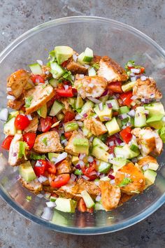 a glass bowl filled with chopped vegetables on top of a table