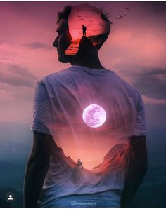 a man standing on top of a hill under a pink sky with a full moon