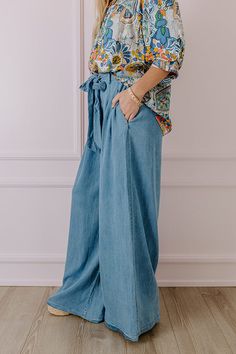 - Go with this flow in these trendy pants! - Unlined chambray material - A waistline with an elastic back, belt loops, and a removable tie closure belt - Pleated details on front - Functional side pockets - A relaxed silhouette that ends in wide floor length hemlines Trendy Denim Belted Bottoms, Trendy Belted Bottoms In Medium Wash, Trendy Belted Medium Wash Bottoms, Trendy Medium Wash Belted Bottoms, Belted Denim Blue Bottoms In Denim, Casual Belted Bottoms In Denim Blue, Belted High Waist Dark Wash Bottoms, Belted Denim Blue Bottoms, Chic Belted Denim Blue Bottoms