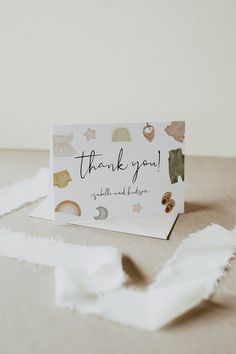 a thank you card sitting on top of a table