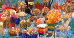 a table filled with lots of candy and lollipops