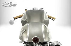 the front end of a silver motorcycle on a white background