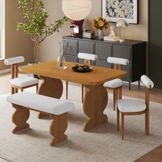 a dining room table with white chairs around it