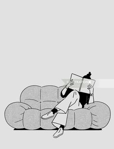 a woman sitting on top of a couch reading a book in front of her face