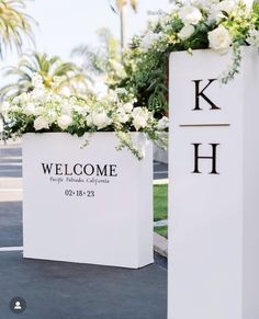 two large white boxes with flowers in them