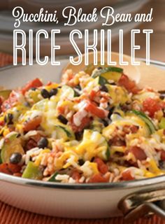 a bowl filled with rice, black beans and veggies on top of a table