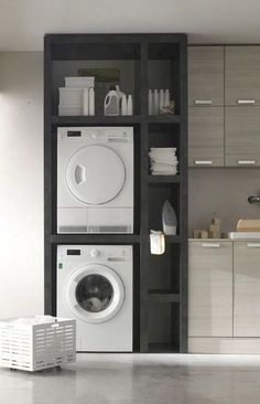 a washer and dryer in a room with cabinets