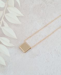 The square pendant necklace is stylish and a versatile piece of jewellery that adds a touch of modern sophistication to any outfit.  The pendant is shiny and polished measuring 10mm x 10mm.  The necklace is gold plated. Square Dainty Jewelry Gift, Simple Rectangular Necklace For Gift, Minimalist Silver Square Necklace, Elegant Rectangular Charm Necklaces For Everyday, Square Pendant Necklace With Adjustable Chain, Minimalist Square Silver Necklace, Modern Jewelry With Clavicle Chain And Square Pendant, Modern Everyday Necklace With Square Pendant, Modern Rectangular Clavicle Chain Necklace