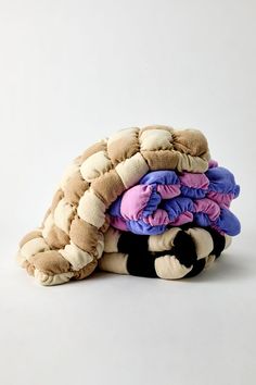 a pile of stuffed animals sitting on top of each other in front of a white background