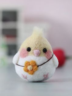 a small stuffed bird sitting on top of a table