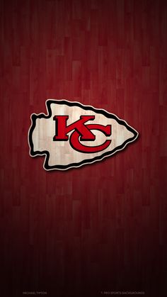 the kansas chiefs logo on a wooden background