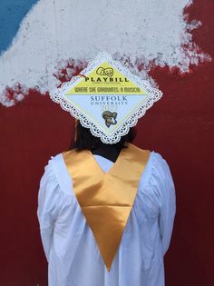 a woman wearing a yellow neck tie with a sign on her head that says playbill