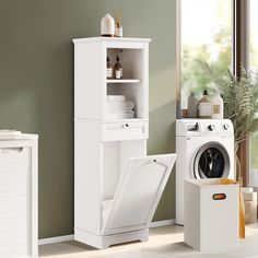 a washer and dryer in a room with green walls