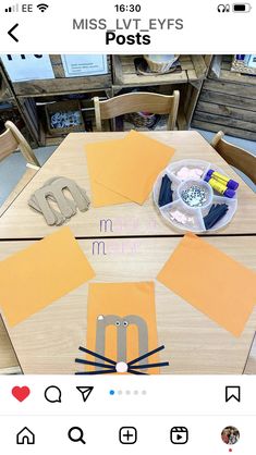 an image of a table with some letters and paper on it, including the letter m