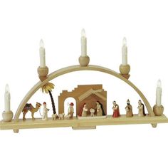 a nativity scene with candles and figurines in the shape of an arch