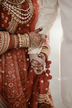 the bride and groom are holding hands together