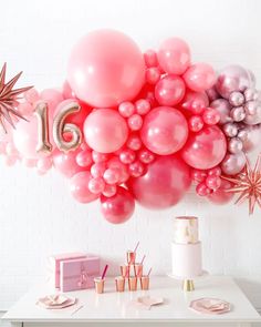 a table topped with lots of balloons and confetti