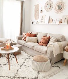 a living room filled with lots of furniture and decor on top of a white rug