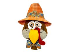 an owl wearing a hat and glasses with a large bird on it's back