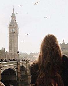 a group of people standing in front of a clock tower