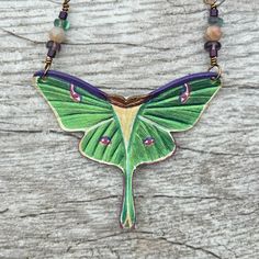 Hand tooled and painted luna moth leather necklace with gemstone accents. #leatherjewelry #lunamothnecklace #mothjewelry #insectjewelry #leathercraft #handmadejewelry Moth Necklace, Creative Words, Leather Necklace, Leather Jewelry, Leather Craft, Nature Inspired, Nature Lover