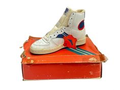 80s  trion high tops. deadstock. NIB. white leather upper with blue and red detail. blue rubber soles. foam tongue. legit. legitjr.etsy.com legitvintage on instagram Throwback High-top Basketball Sneakers With Round Toe, Throwback High-top Basketball Shoes With Gum Sole, Throwback High-top Sneakers With Round Toe For Basketball, Throwback Round Toe High-top Sneakers For Basketball, Retro High-top Basketball Shoes With Gum Sole, High-top Basketball Shoes With Gum Sole, Vintage High-top Basketball Shoes, Retro High-top Basketball Sneakers, Retro High-top Basketball Shoes With Rubber Sole