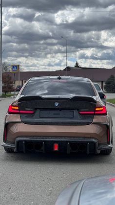 the rear end of a bmw car parked in a parking lot