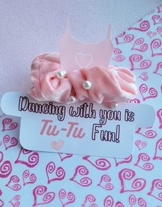 there is a pink bow on top of a sign that says dancing with you is fun