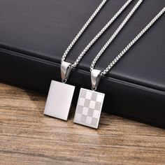 Stainless Steel Checkered Rectangular Tag Pendant Necklace for Men - Elevate Your Style with Chess-Inspired Elegance Description: Add a touch of sophistication to your ensemble with our Checkered Rectangular Pendant Necklace for Men. Crafted from durable stainless steel, this necklace features a stylish checkered design in gold, silver, or black color options, reminiscent of a classic chessboard. Perfect for layering or wearing solo, this trendy necklace is sure to make a statement at any occasion. Specifications: Occasion: Party Compatibility: All Compatible Pendant Size: 15mm*20mm Shape/Pattern: Round Model Number: NC-913GMP Material: Metal Chain Type: Link Chain Style: TRENDY Necklace Type: Pendant Necklaces Gender: Men Metals Type: Stainless Steel Fine or Fashion: Fashion Item Type: Ne Color Checker, Necklace Men, Necklace Chain Lengths, Trendy Necklaces, Men Model, Mens Pendant, Geometric Pendant, Metal Necklaces, Round Pendant