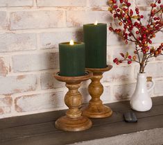 two candles are sitting next to each other on a table