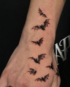 a man's hand with bats on it