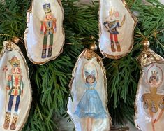 four ornaments are hanging from a christmas tree