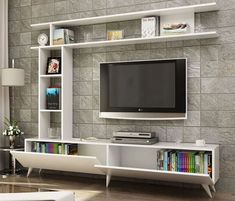 there is a tv on the wall in this living room with bookshelves and shelves