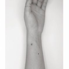 a person's arm with a small pi symbol on it