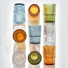 four different colored glass cups sitting next to each other