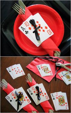 the table is set with playing cards and forks