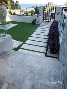 an outdoor area with grass and stairs