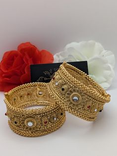 Indian bollywood fashion Kundan 2pcs openable bridal wedding gold plated bangles / kangan set These are high quality gold plated bangles set. Have done gold plating on it for a brilient shine. These looks great when you worn alone or in pair. They are sure to make your hands look beautiful. A popular combo to wear with many outfits. A perfect gift for your loved ones or yourself.  A perfect ornament for wedding, parties or any special event.  Stone Colour: Emerald, Ruby Pink, Clear 1 Bangles Surface Width: 3.4 cm Product colour may slightly vary due photographic lighting sources or your monitor settings.  Bangles sizes 2.25 inches = size 2.4  2.375 inches = size 2.6  2.5 inches = size  2.8 2.625 inches = size 2.10 Bohemian Bangle For Wedding And Festive Occasions, Bohemian Wedding Bangle For Festive Occasions, Kundan Bracelets For Marriage And Festivals, Bohemian Stone Work Bracelets For Wedding, Bohemian Bracelets With Stone Work For Wedding, Bohemian Heavy Bangle For Wedding, Heavy Bohemian Bangle For Wedding, Festive Bohemian Bracelet For Weddings, Bollywood Style Bracelets For Wedding And Diwali