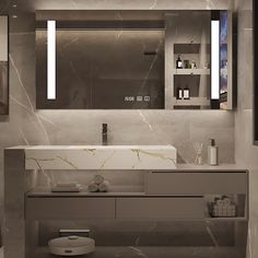 a bathroom with marble walls and flooring is pictured in this image, there are lights on the mirror above the sink