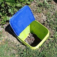 a blue and yellow container with rocks in it