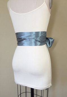 "Steel Gray Sash Silver Gray Satin Sash Obi Wrap Belt Long Silver Sash Wedding Accessories Wedding Gown Bridal Sash Satin Swank Make this Satin Swank® reversible waist sash the perfect finishing touch for your wedding, bridesmaid, or special occasion dress, or just the right piece to add instant polish to your dress or top. This extra long version is 3.5 inches wide, 120 inches long, and will wrap around most waist sizes two times with a generous length remaining to tie in a bow or a simple knot Wedding Satin Tie Back Sash, Fitted Ribbon Sash For Wedding, Wedding Sashes With Satin Finish, Fitted Bridal Belt With Ribbon For Wedding, Gray Sash, Obi Wrap Belt, Gown Bridal, Wedding Sash Belt, Waist Sash