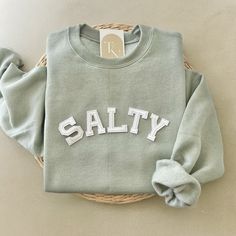 Our Salty crewneck sweatshirt is the perfect trendy minimalistic christian sweatshirt to declare your faith to the Lord! A great for your family, friends, or loved ones. - Sweatshirt is super soft and comfy! ♡  - Sweatshirt composition: 50% cotton, 50% polyester - All our sweatshirts run a unisex fit. They are naturally oversized, so we normally recommend your true size. But if you like a more baggy look, we recommend sizing up. - These letters are iron-on patched and is heat pressed, not embroi Casual Everyday Sweatshirt With Letter Embroidery, Cotton Sweatshirt With Lettering For Everyday, Everyday Cotton Sweatshirt With Lettering, Casual Sweatshirt With Lettering For Everyday, Cotton Sweatshirt With Lettering, Casual Crew Sweater With Letter Embroidery, Casual Crew Neck Hoodie With Letter Embroidery, Casual Everyday Sweatshirt With Lettering, Everyday French Terry Tops With Letter Print