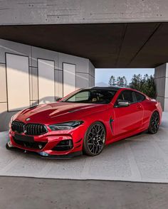 a red sports car parked in front of a building