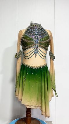 a green and white belly dance costume on display