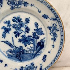 a blue and white plate with flowers on it