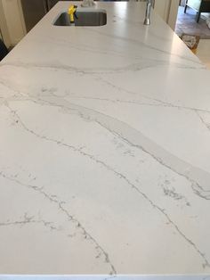 a large white counter top in a kitchen